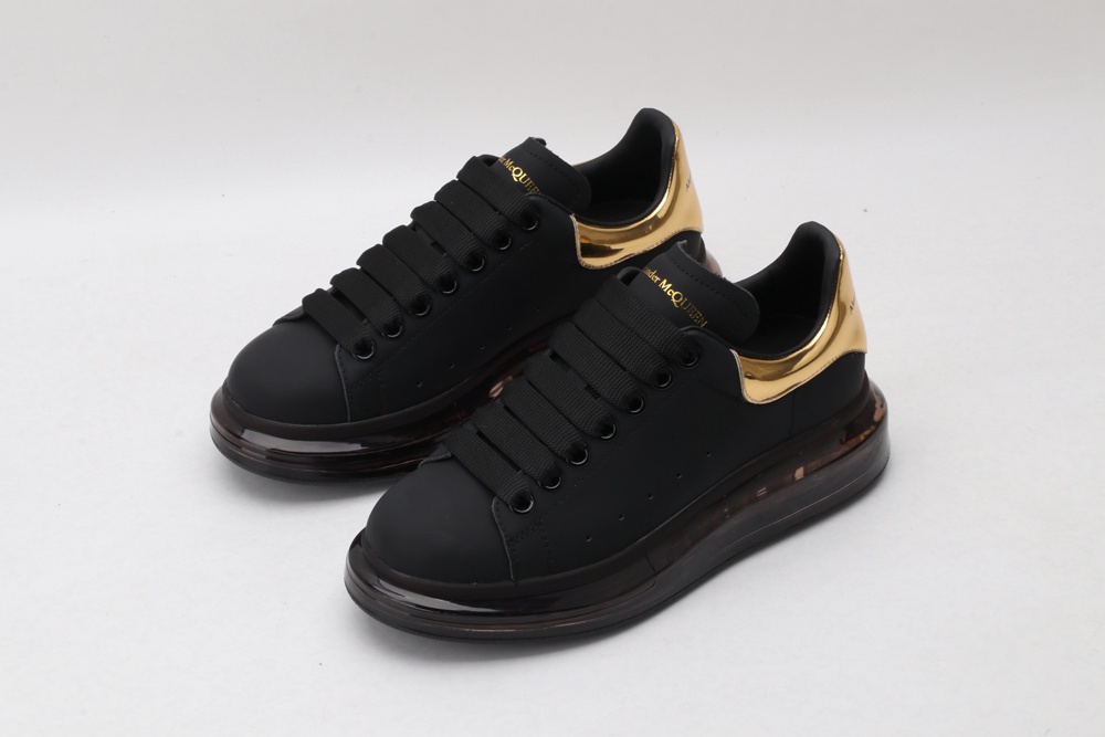 AMQ black oversized sneakers with gold heel