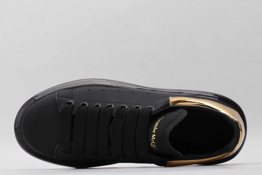 AMQ black oversized sneakers with gold heel