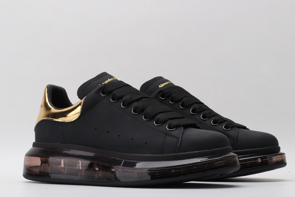 AMQ black oversized sneakers with gold heel