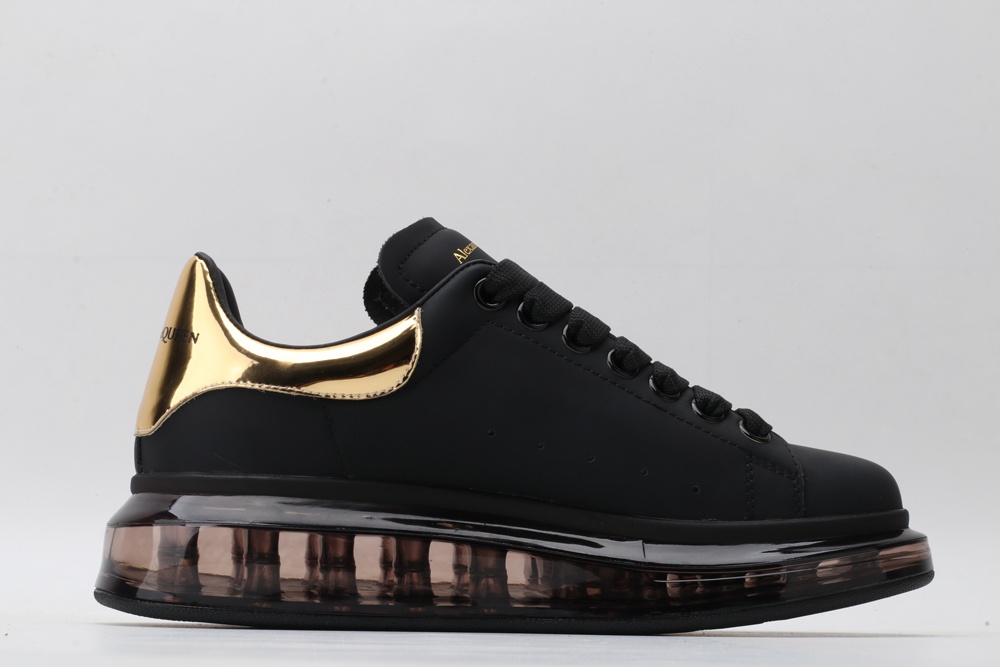 AMQ black oversized sneakers with gold heel