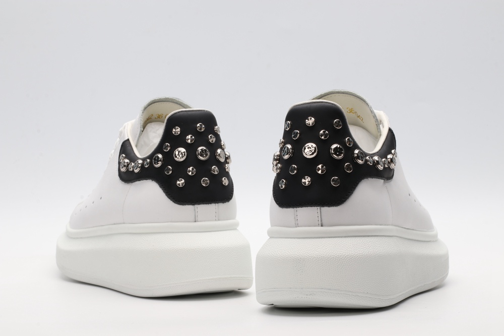 White calf leather lace-up sneaker trimmed with contrasting-color black calf leather heel