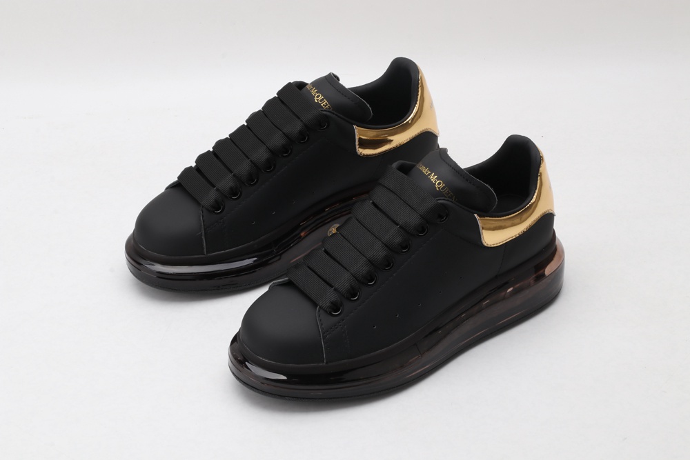 AMQ oversized sneakers black with gold heel