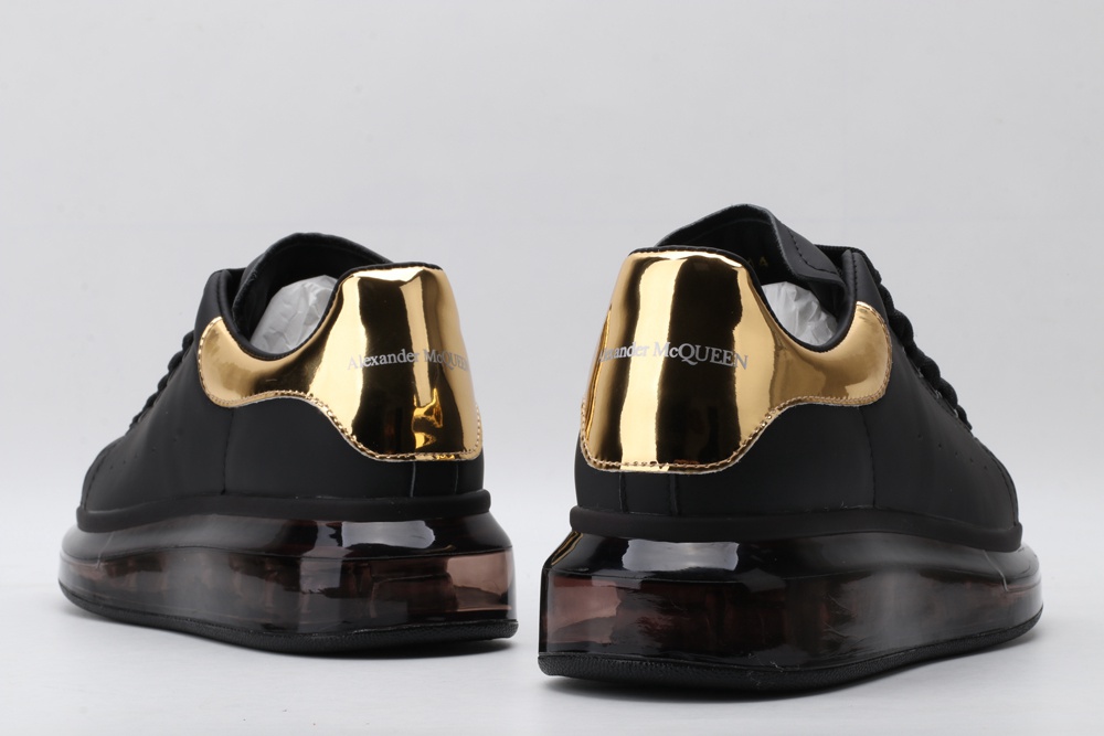 AMQ oversized sneakers black with gold heel