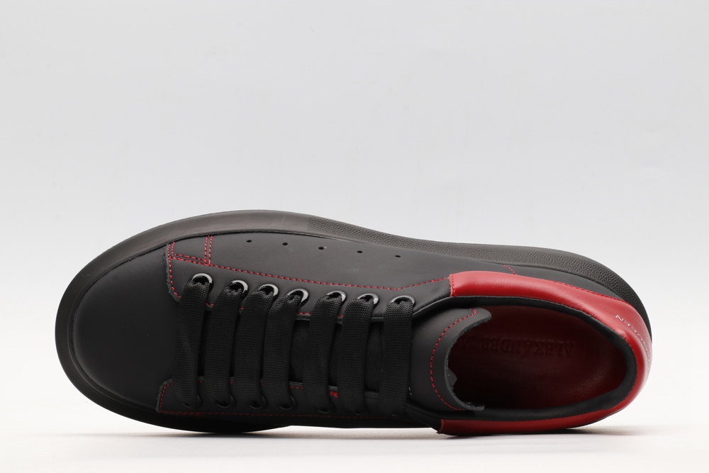 AMQ black oversized sneakers with red heel