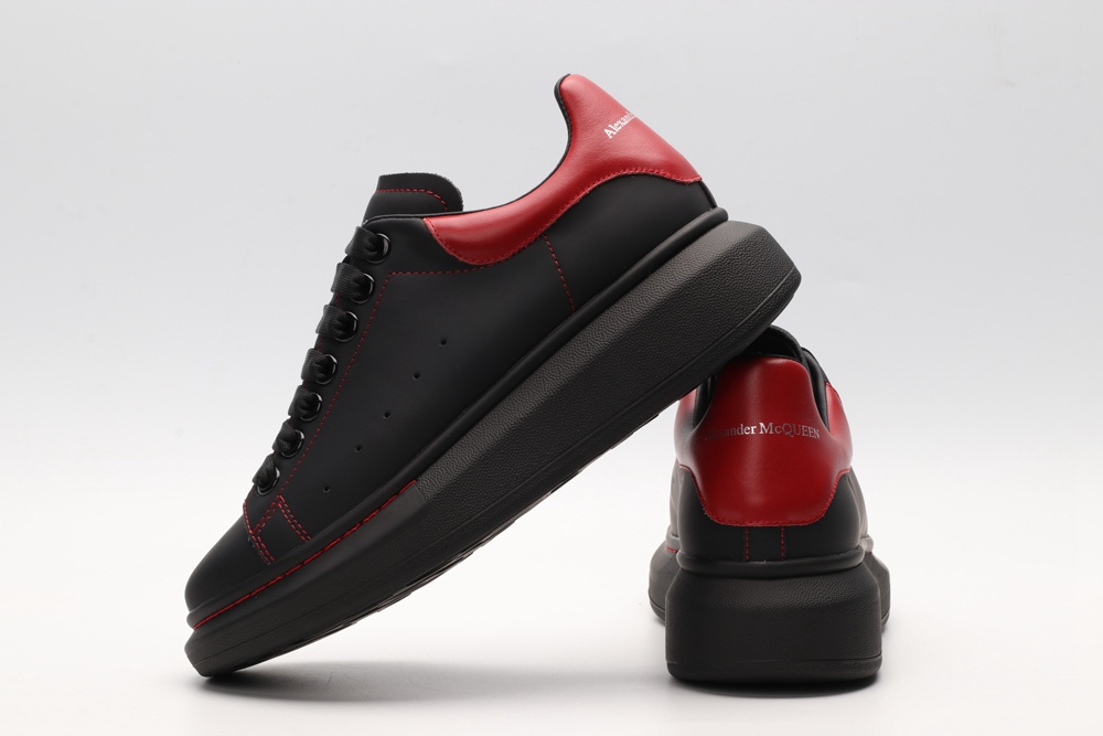 AMQ black oversized sneakers with red heel